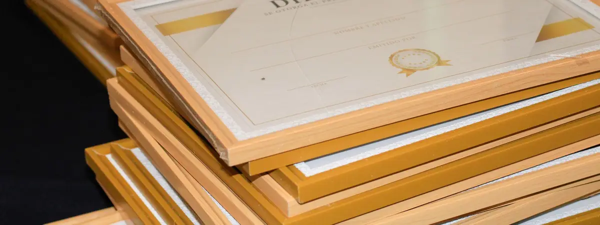 A stack of framed diplomas ready for a graduation ceremony