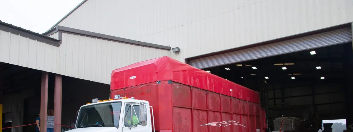 A trailer truck backed into a warehouse loading dock