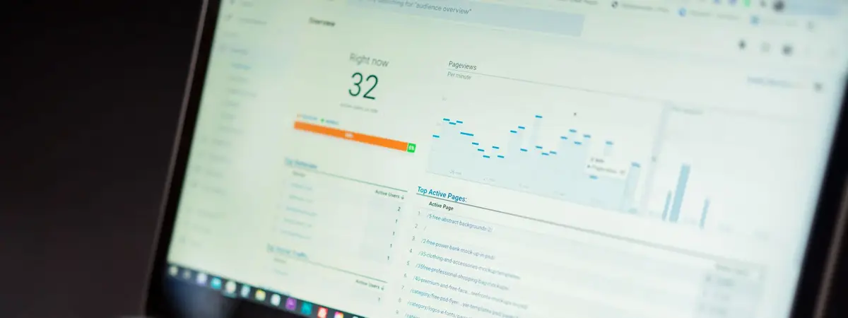 A laptop showing an analytics dashboard of charts