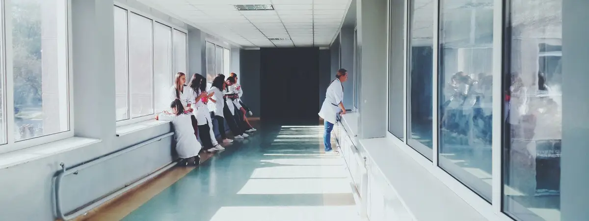 Medical staff in white coats in a bright hospital hallway