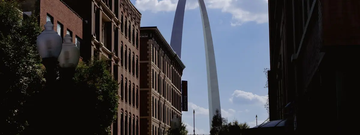 The Gateway Arch between downtown buildings in St. Louis, Missouri